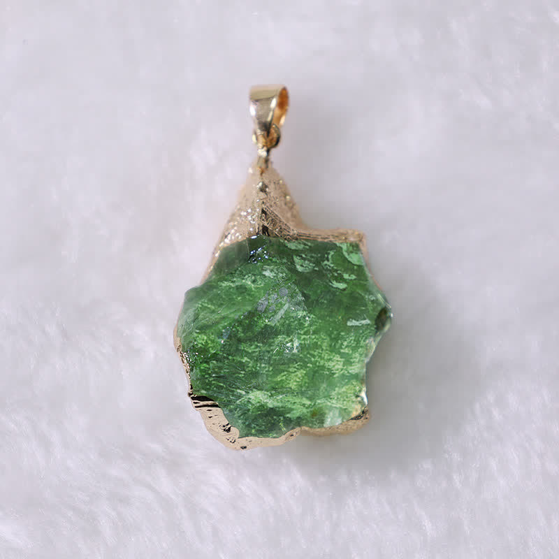 Raw natural Moldavite gemstone pendant on a women's necklace, a unique cosmic spiritual jewelry piece.