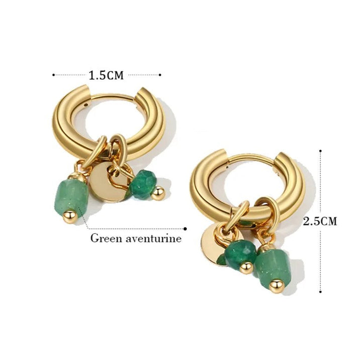 Close-up of elegant women's natural stone gold hoop earrings, showcasing unique gemstones and polished gold.