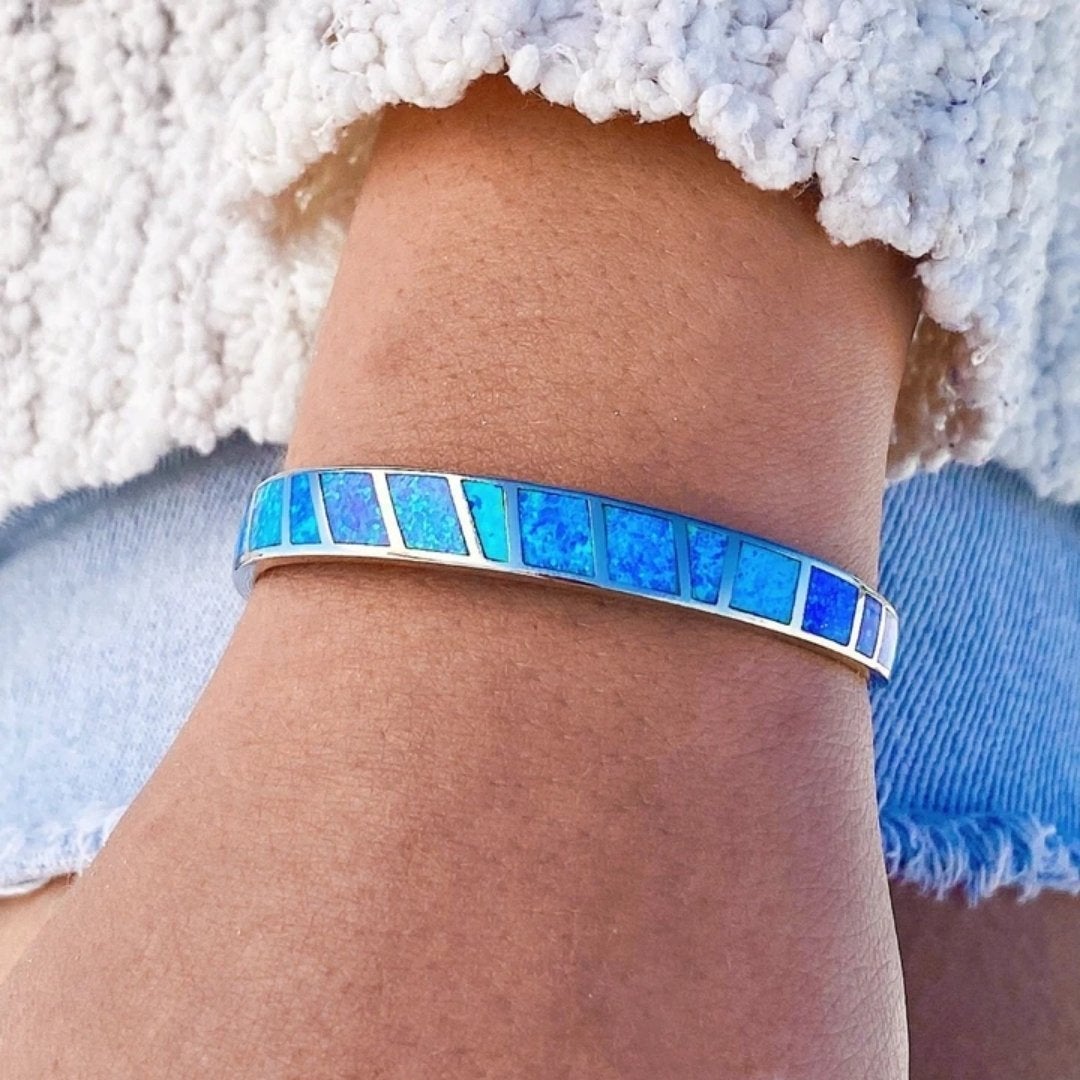 Delicate silver bracelet featuring vibrant blue opal stones, perfect elegant jewelry for women.