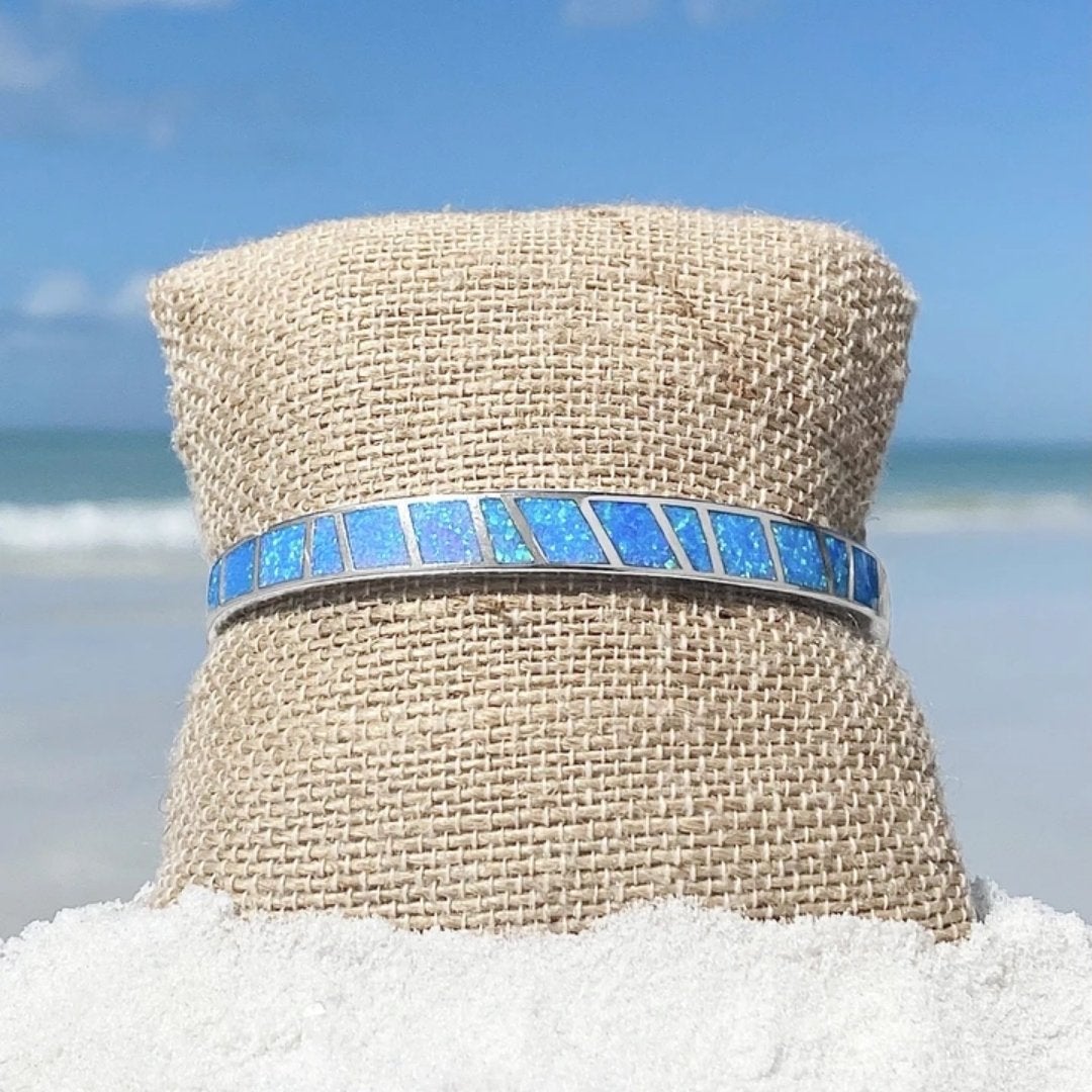 Women's silver bracelet with striking blue opal gems, an ocean-inspired and elegant accessory for any occasion.