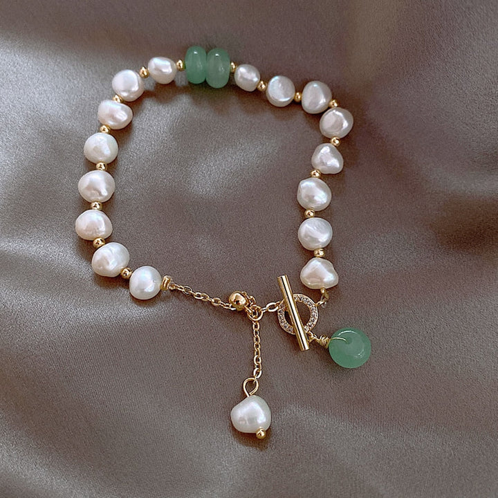 Elegant women's ocean pearl adventure bracelet, handcrafted with adjustable chain for a perfect fit. Fine jewelry.