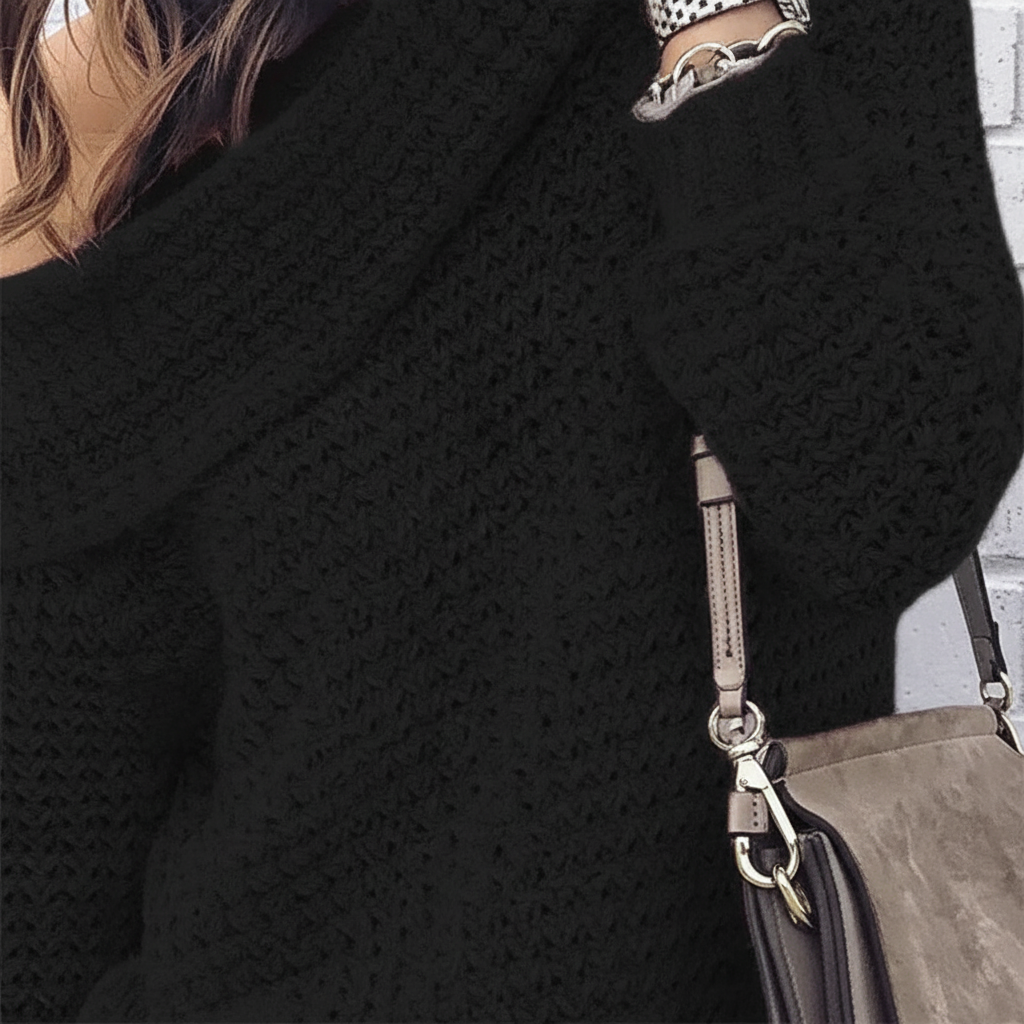 Close-up of a white off-shoulder knit sweater, highlighting the soft acrylic wool texture and elegant design.