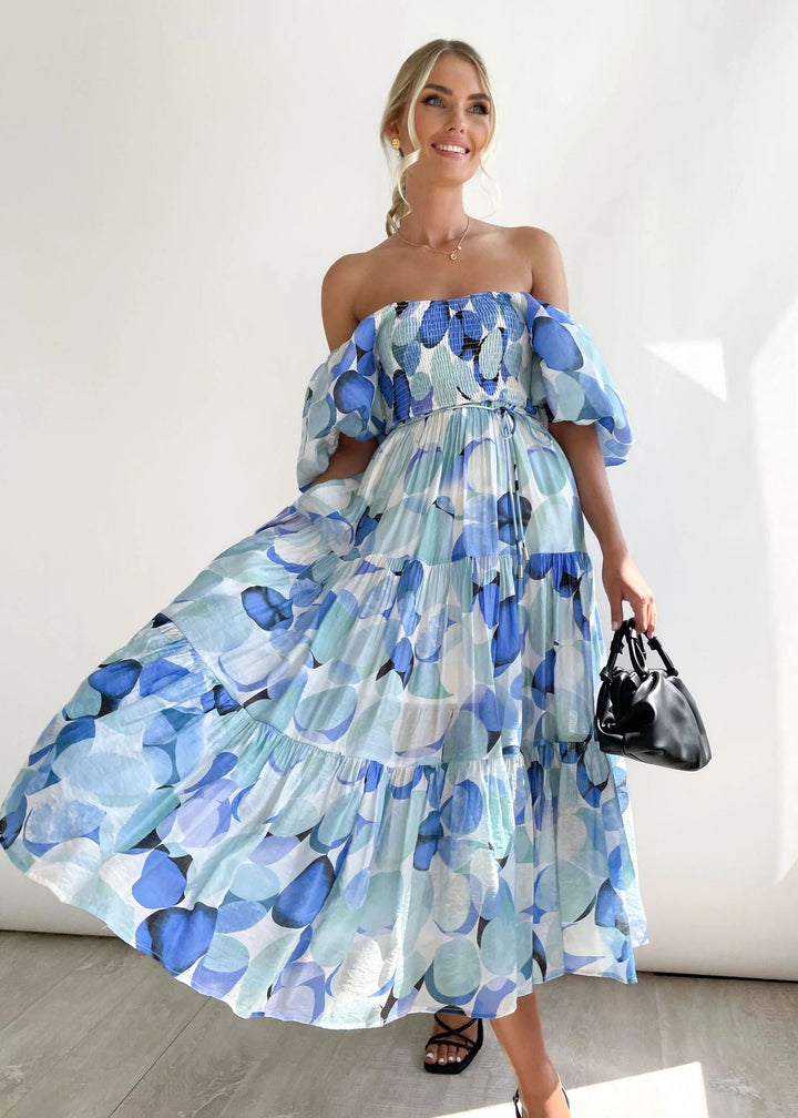 Stylish women's off-shoulder midi dress with delicate ruffles, a beautiful flowing vacation or summer party dress.