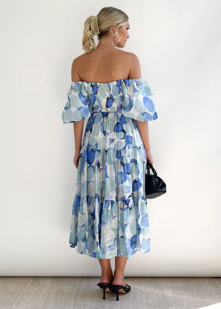 Flowing women's off-shoulder midi dress with ruffles, a comfortable and elegant summer dress for any occasion.