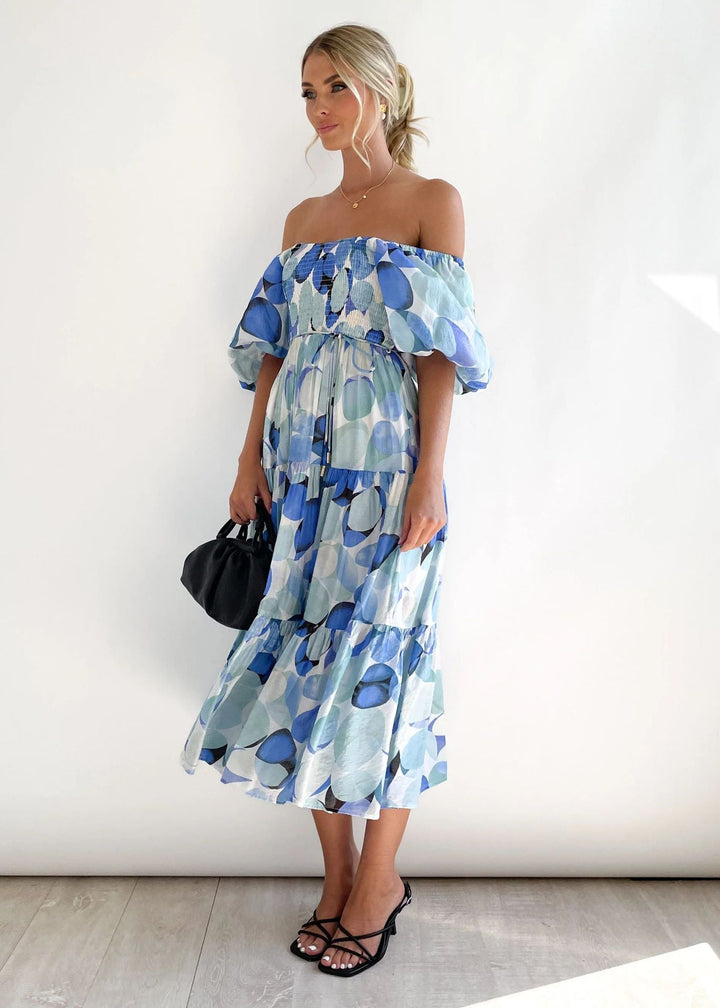 Trendy women's off-shoulder midi dress with playful ruffles. A chic and elegant piece for modern women's fashion.