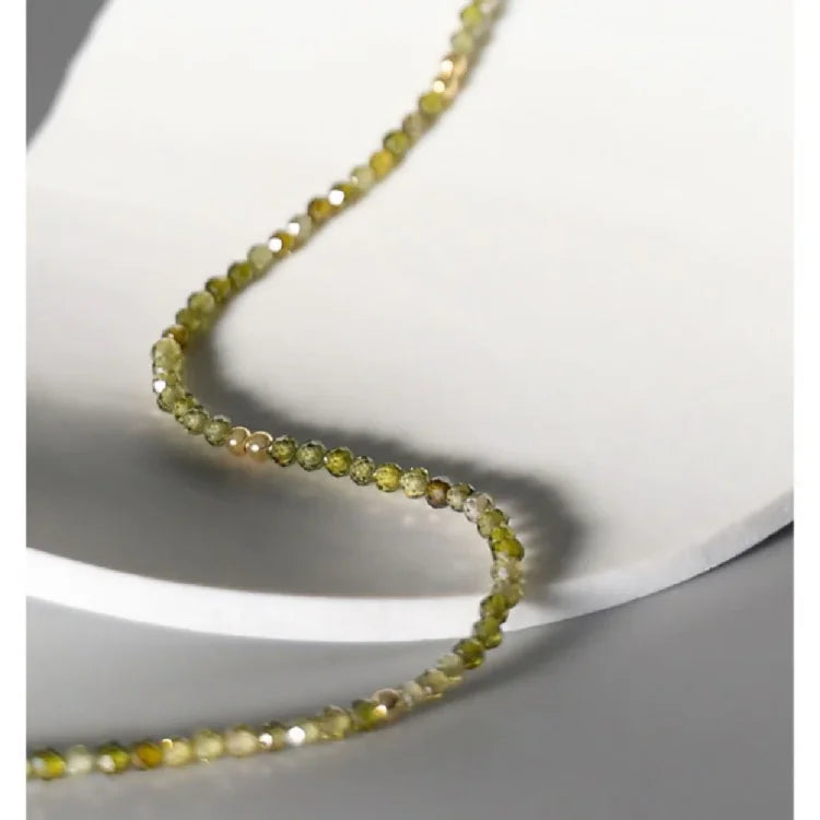 Gold-plated sterling silver women's necklace featuring a beautiful olive green zirconia stone.