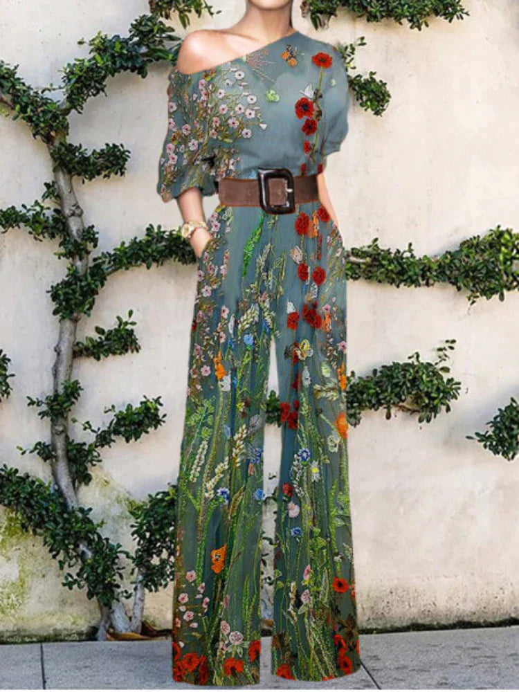 Modern women's flowy printed one-shoulder jumpsuit with wide legs, great for elegant summer events.