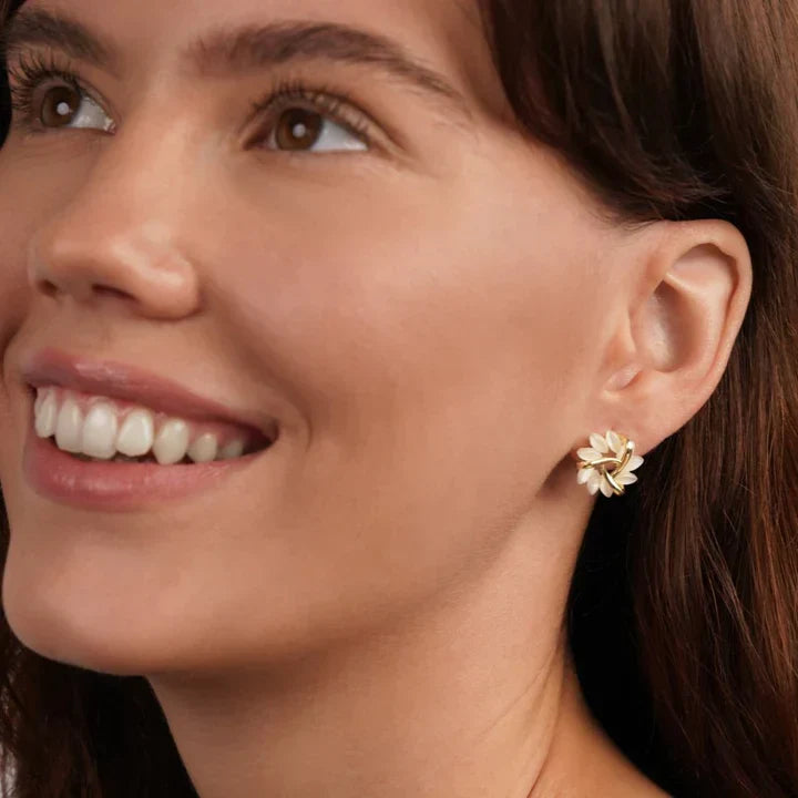 Close-up of elegant opal flower petal earrings, highlighting their intricate design and shimmering opals.