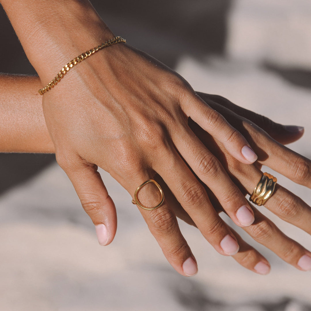 Close-up of shimmering gold oval ring, a durable and elegant women's everyday jewelry.