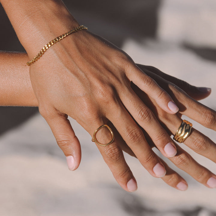 Close-up of shimmering gold oval ring, a durable and elegant women's everyday jewelry.
