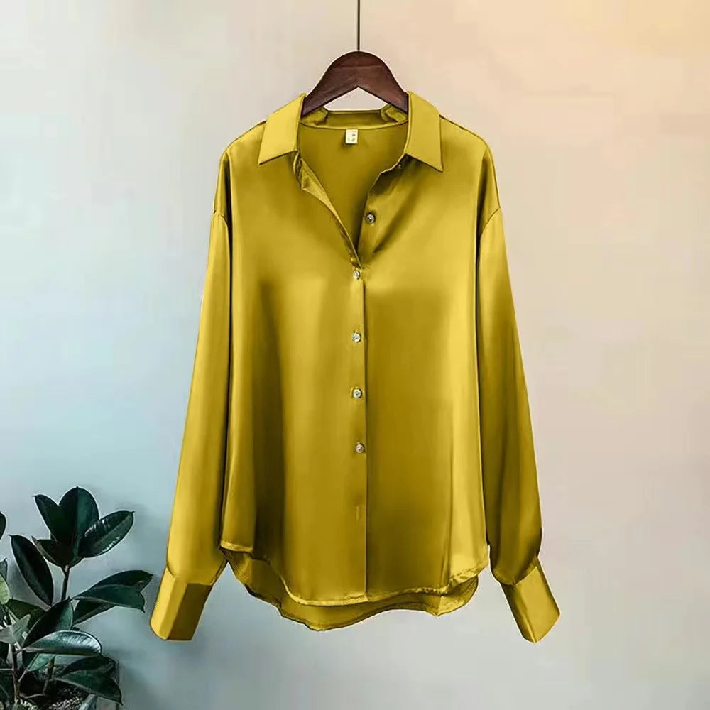 Fashionable blue oversized button-up shirt for women, featuring a classic button-up design & long sleeves.