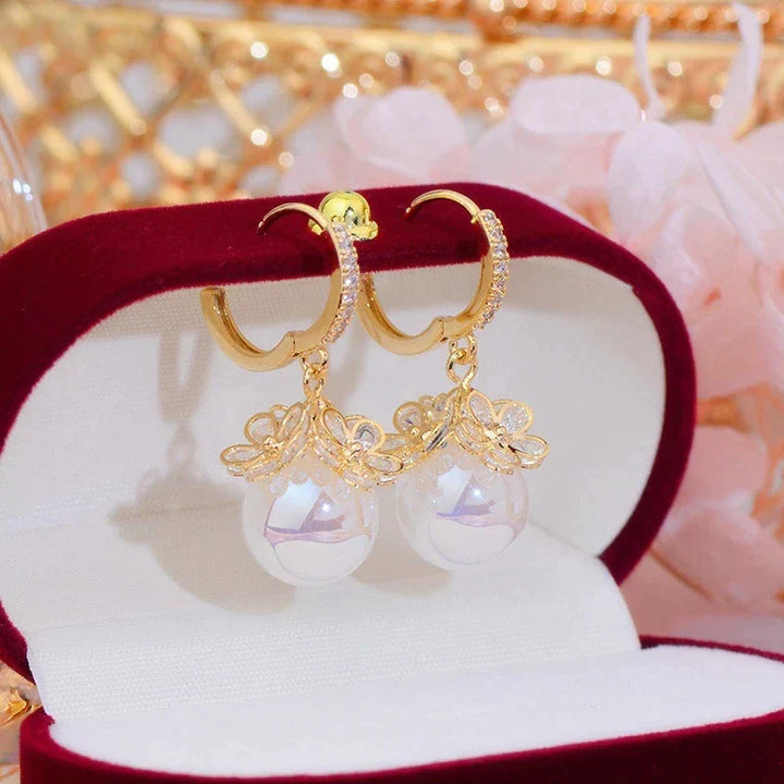 Elegant women's pearl drop earrings, featuring timeless freshwater pearls & sterling silver hooks. Perfect gift.