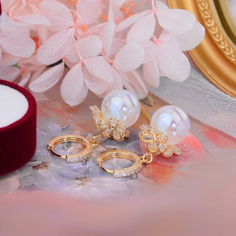 Delicate freshwater pearl drop earrings for women, showcasing round white pearls on elegant sterling silver.