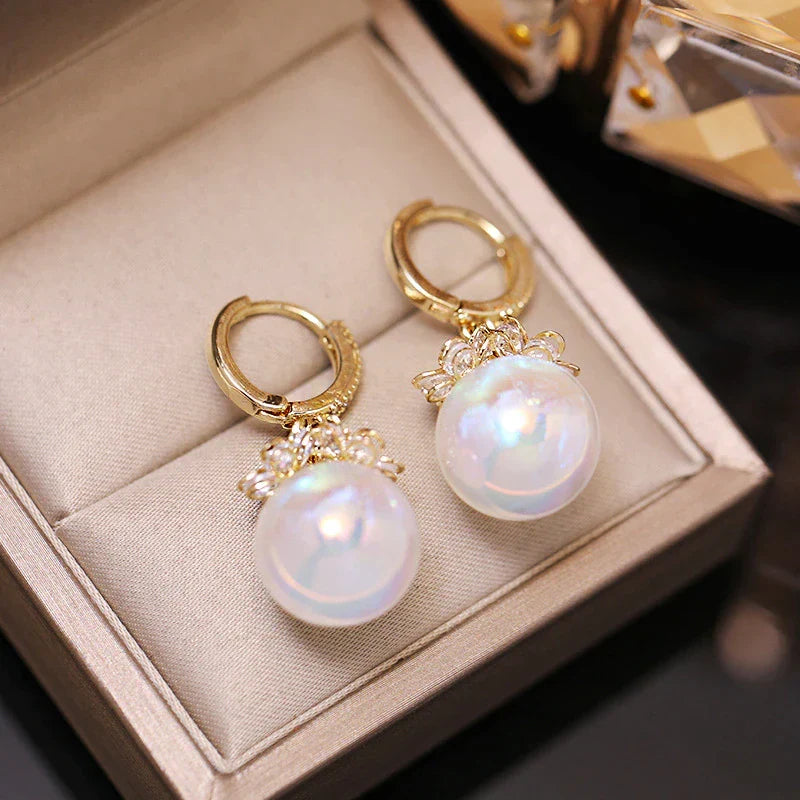 Close-up of elegant women's pearl drop earrings. Lustrous freshwater pearls gleam against sterling silver.