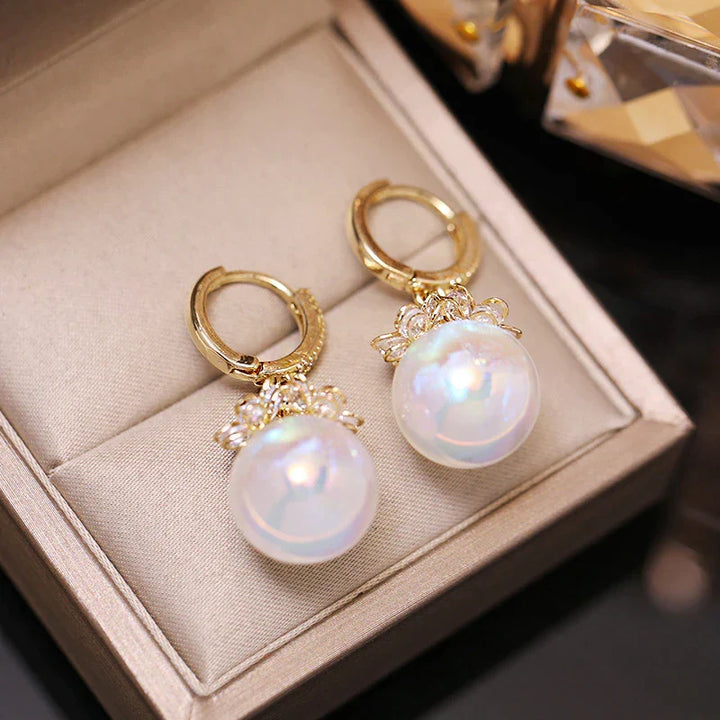 Close-up of elegant women's pearl drop earrings. Lustrous freshwater pearls gleam against sterling silver.