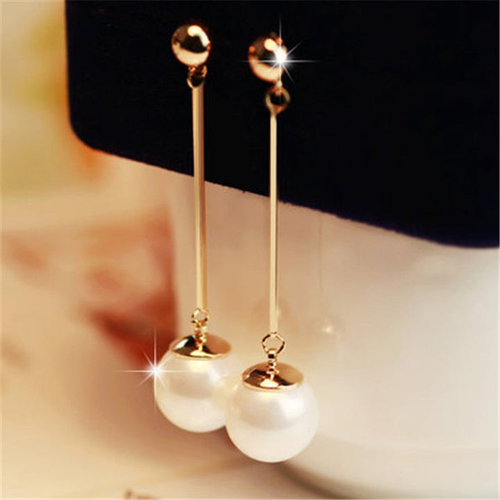 Elegant women's pearl drop earrings, luxury handcrafted design. Gold-plated fine jewelry for timeless style.