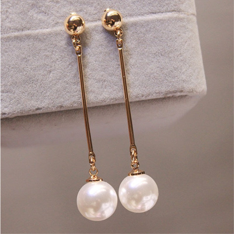 Luxurious pearl drop earrings for women. Close-up of elegant handcrafted silver-toned jewelry, perfect gift idea.