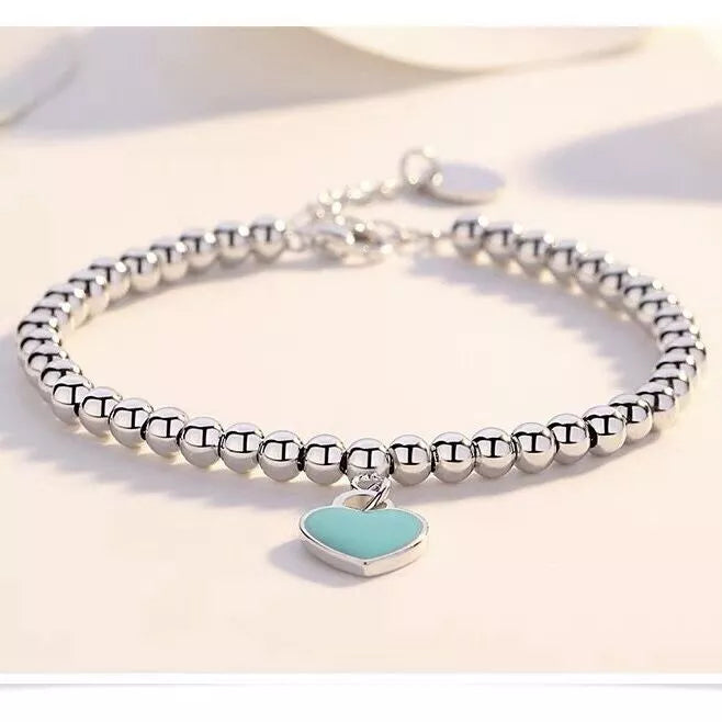 Elegant women's pearl heart bracelet with blue pearls, perfect as a romantic jewelry gift or sophisticated fashion accessory.