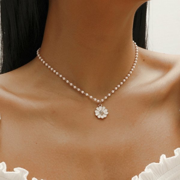 Elegant women's pearl necklace with a delicate silver daisy pendant, perfect floral jewelry gift.