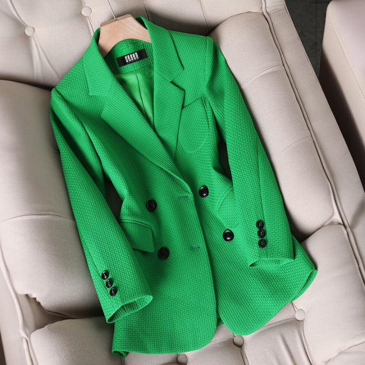Close-up of a women's plaid blazer jacket, highlighting the fabric texture and tailored fit