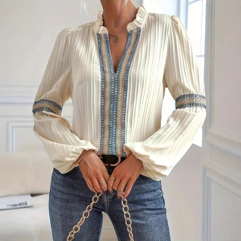 Stylish women's pleated blouse with high collar and fluted sleeves, enhanced by elegant lace trim.