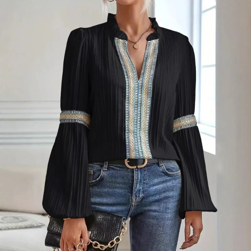 Fashionable women's pleated top, designed with intricate lace trim and an elegant high collar. A stylish blouse.
