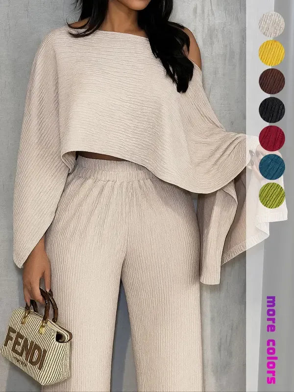 Women's one-shoulder pleated chiffon top with matching wide-leg pants. Chic two-piece summer outfit, ideal for resorts.