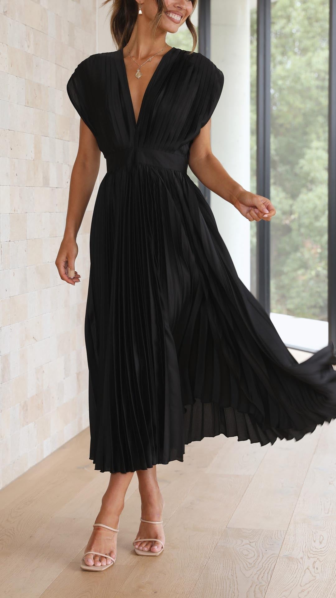 Elegant women's V-neck pleated gown, long and flowing, perfect for special occasions.
