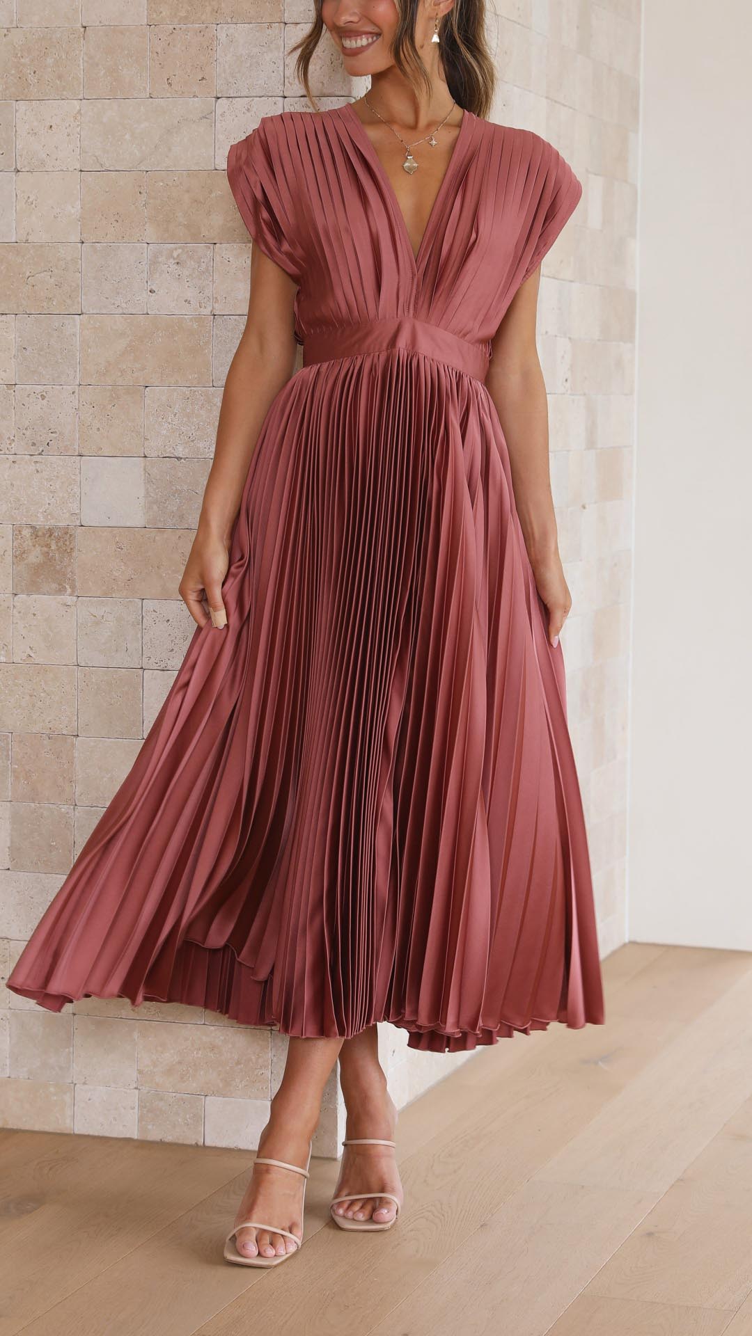 Women's formal deep V-neck gown, flowing pleated maxi skirt, elegant special occasion wear.