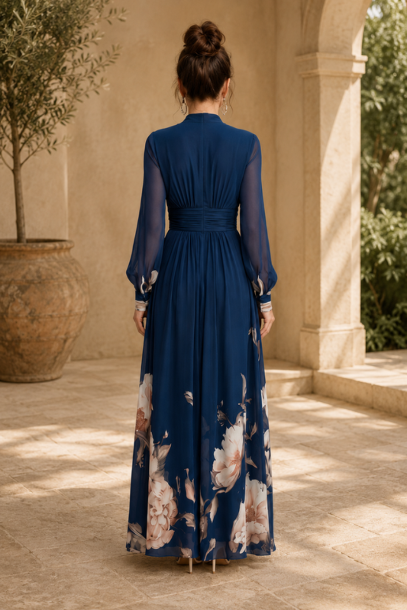 Women's elegant evening maxi dress with sheer sleeves and a flowing pleated skirt, ideal for formal events.