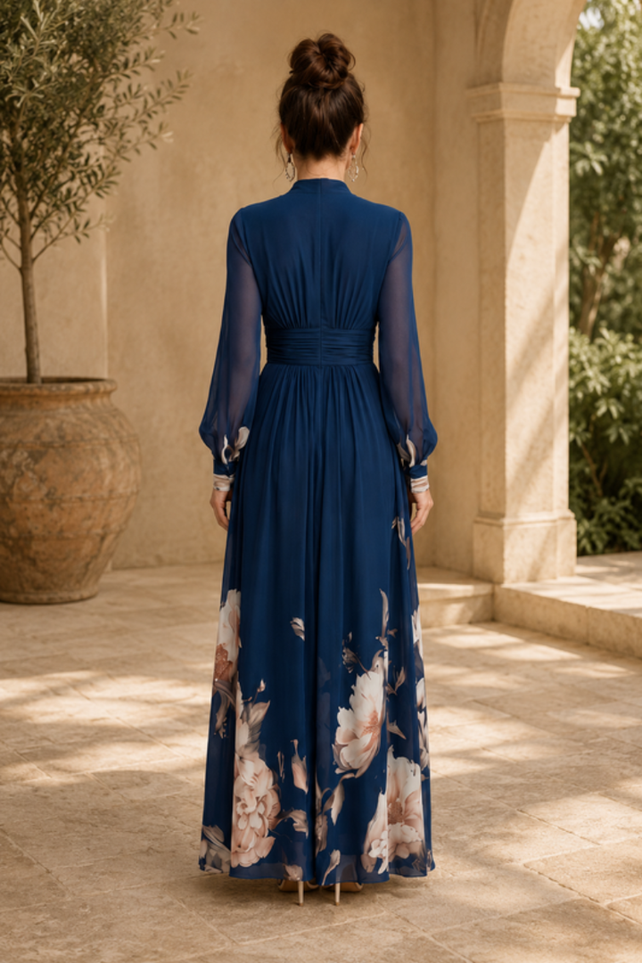 Women's elegant evening maxi dress with sheer sleeves and a flowing pleated skirt, ideal for formal events.