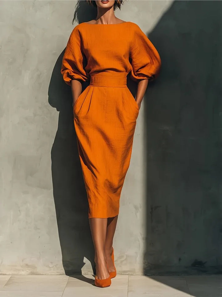Elegant women's pleated midi dress with stylish lantern sleeves and a flattering cinched waist, perfect for office or cocktails.