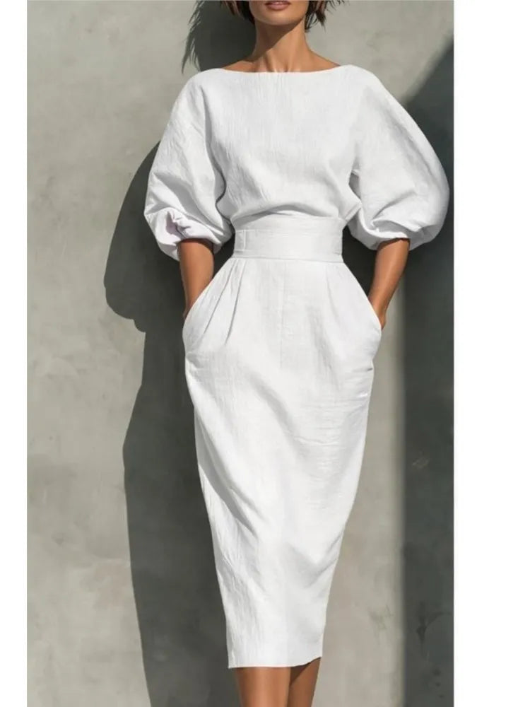 Chic women's elegant midi dress, fully pleated, with stylish lantern sleeves and a defined cinched waist for a polished look.