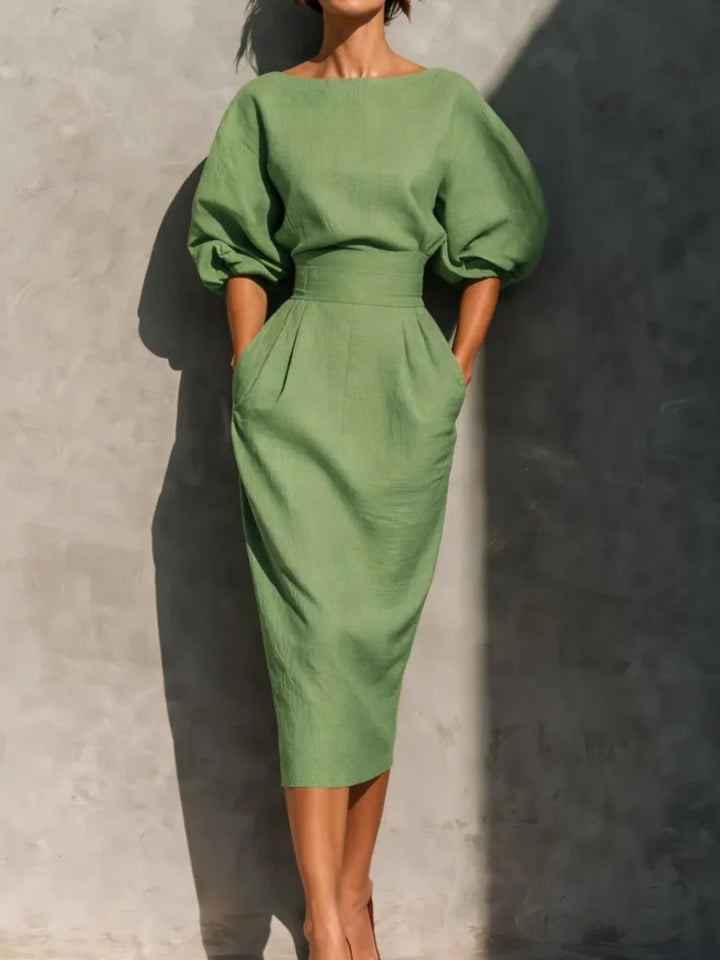 Beautiful women's pleated midi dress, showcasing elegant lantern sleeves and a flattering silhouette ideal for special occasions.
