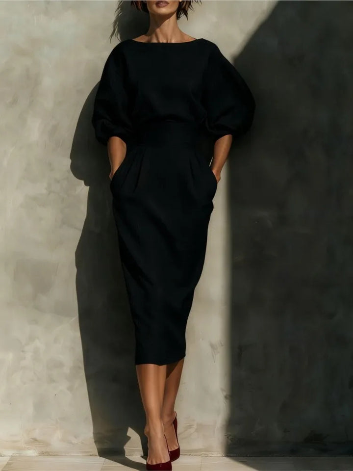 Women's elegant midi dress with a flowing pleated skirt, stylish lantern sleeves, and a cinched waist. Ideal office fashion.
