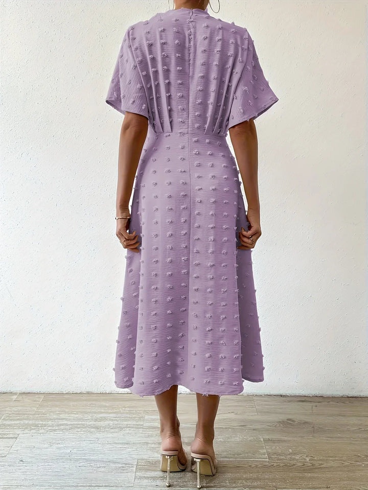 Chic women's midi dress with delicate pleats & cascading ruffles, ideal for cocktails & parties.