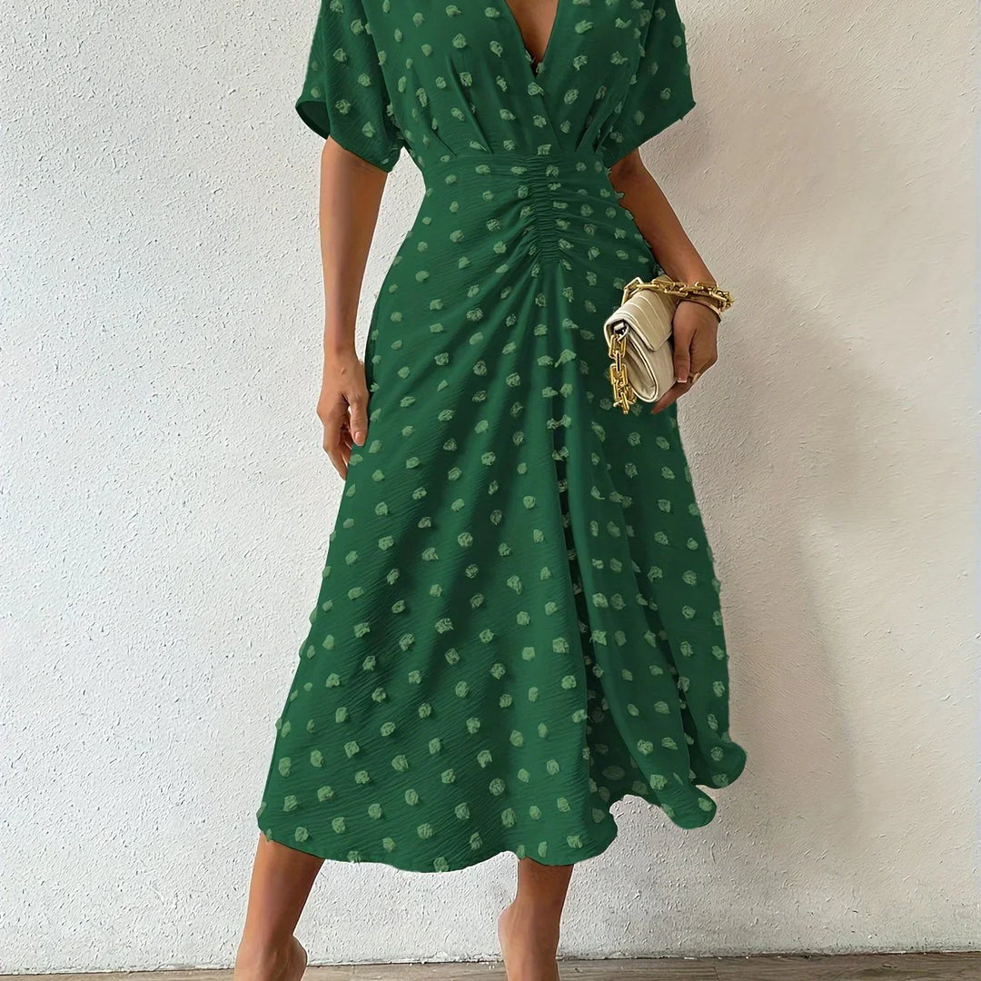 Beautifully pleated women's midi dress with flowing ruffles, an elegant choice for evening wear.