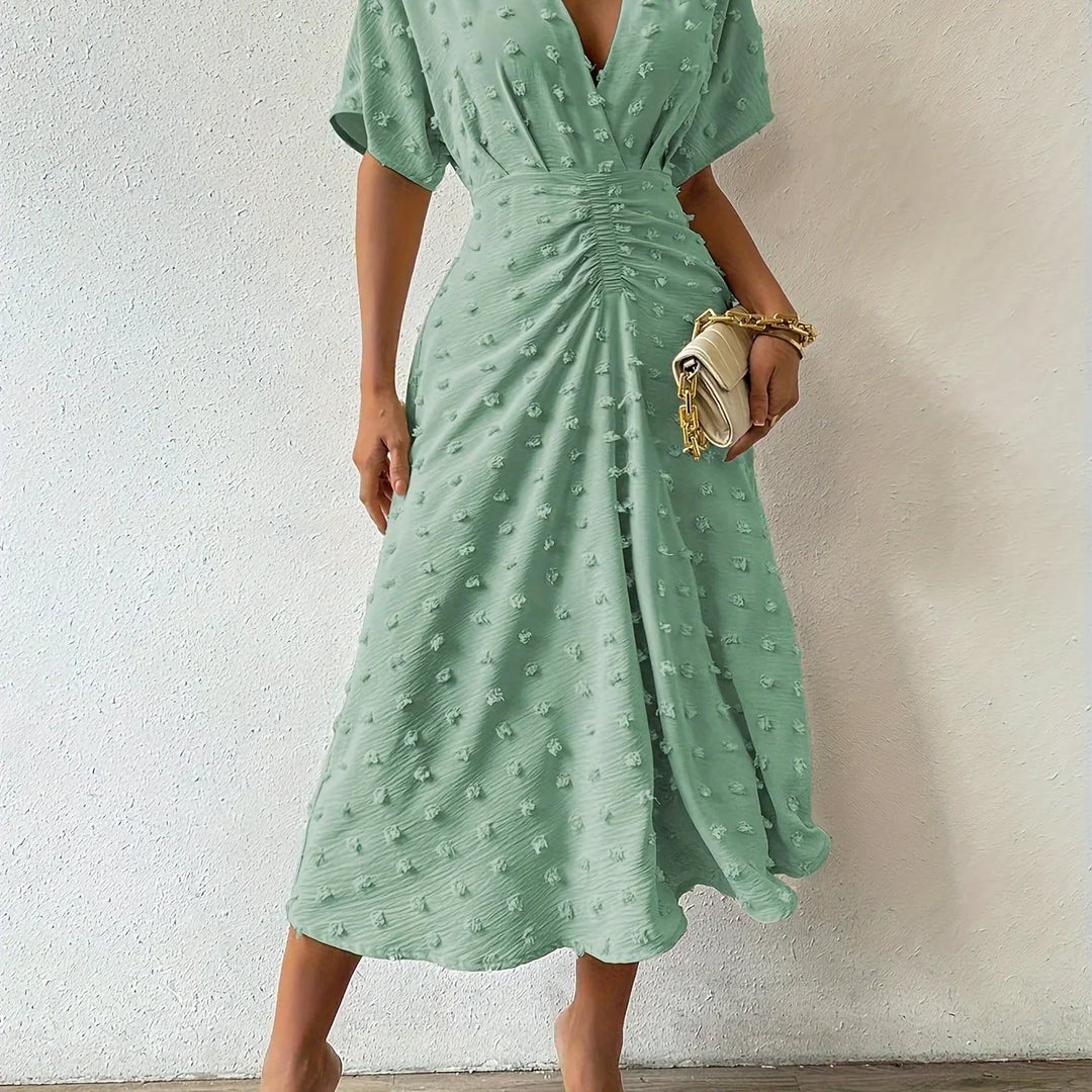 Women's elegant midi dress featuring a pleated bodice and delicate ruffle skirt, perfect for parties.