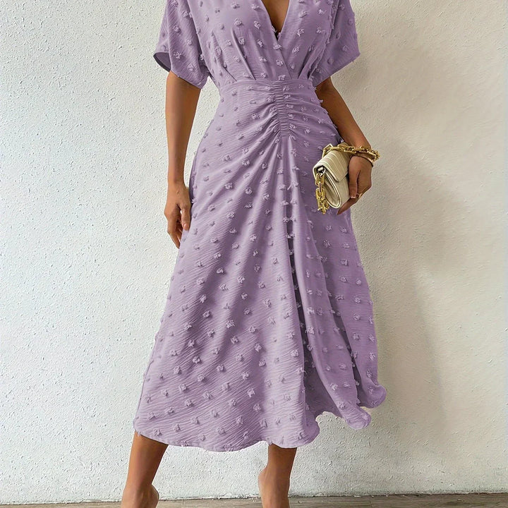 Graceful women's pleated midi dress with charming ruffles, designed for sophisticated evening events.