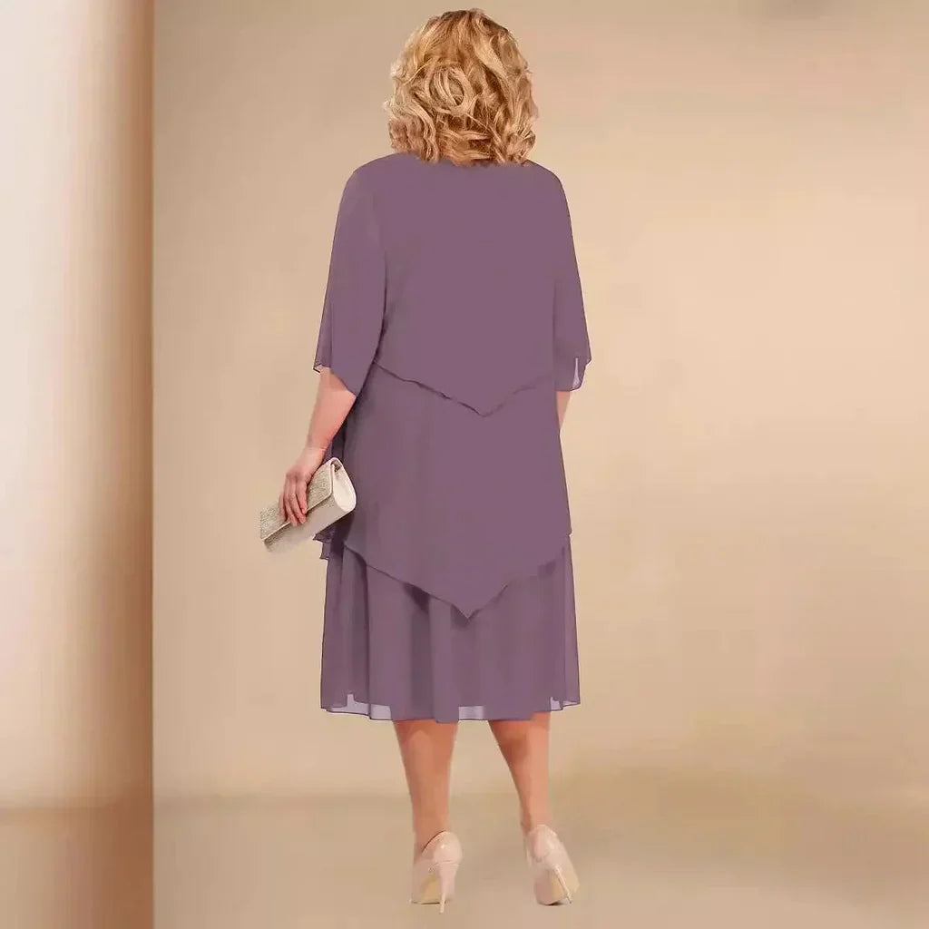 Chic women's formal midi dress in a plus size fit, featuring a unique asymmetrical design for evening wear.