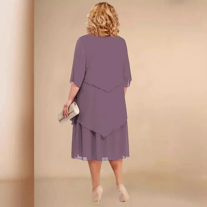 Chic women's formal midi dress in a plus size fit, featuring a unique asymmetrical design for evening wear.