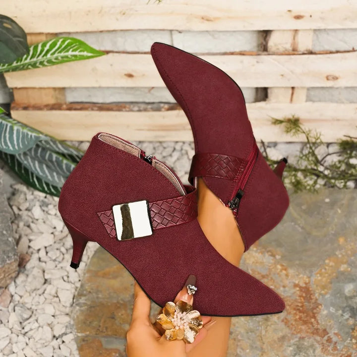 Elegant women's pointed toe heels with a metallic buckle, ideal for formal events.