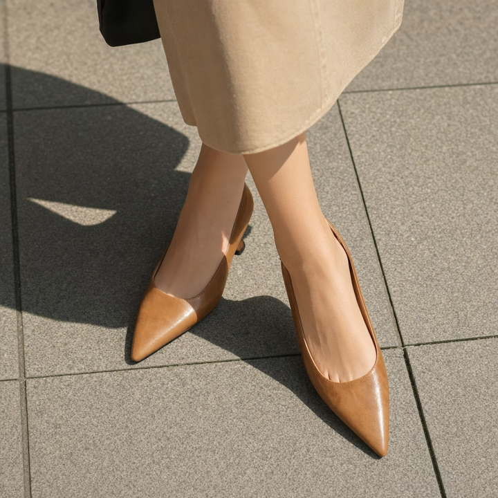 Stylish women's black pointed-toe dress pumps with a thin heel for work or formal events.