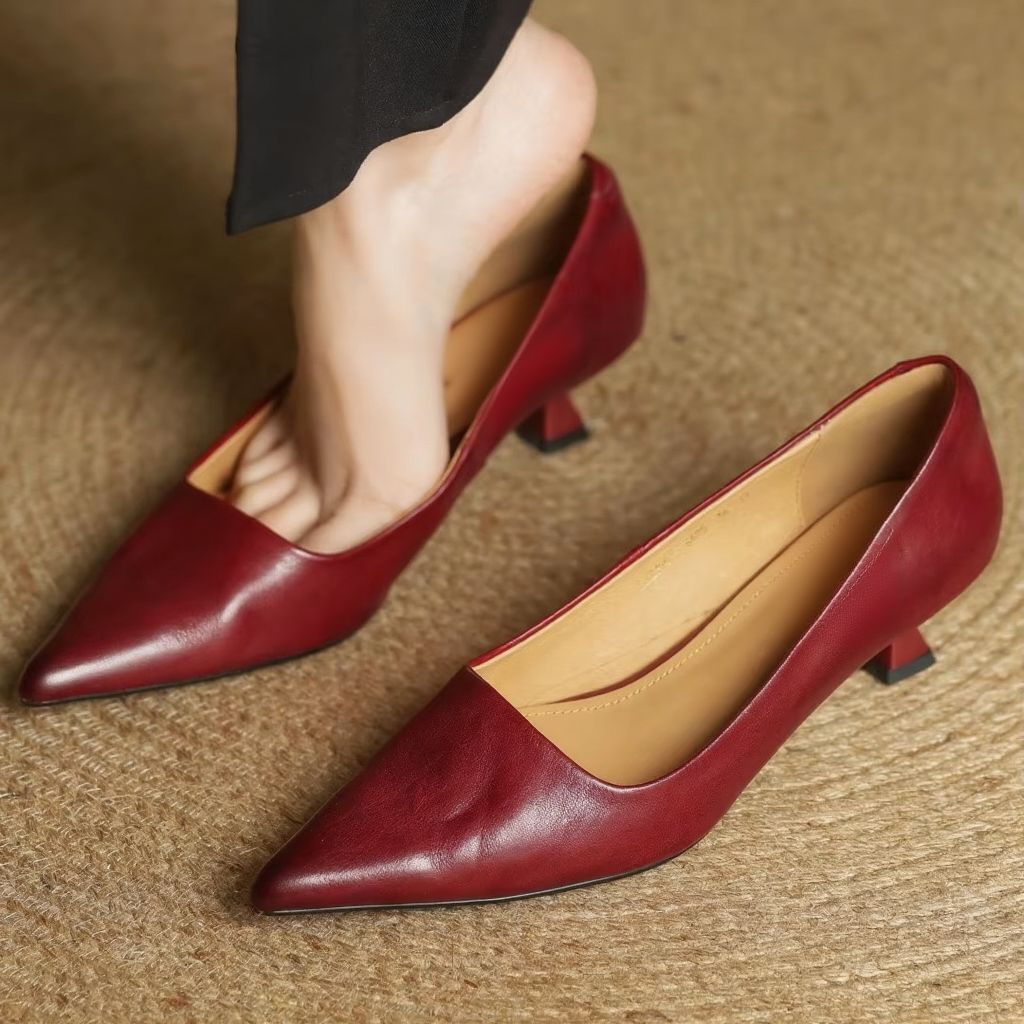 Bold red women's pointed-toe slip-on pumps, thin heel for a confident fashion statement.