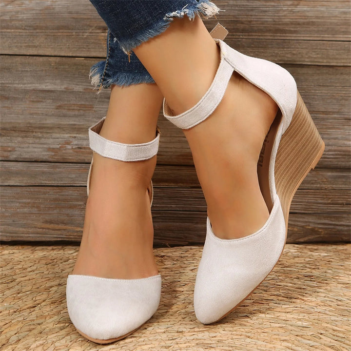 Elegant women's pointed toe wedge heels with a supportive ankle strap, perfect for modern comfort and style.
