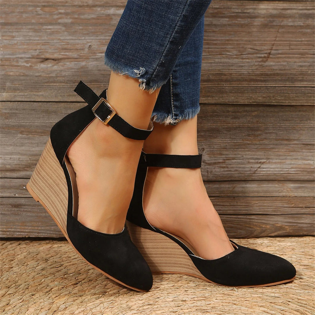 View of women's elegant pointed toe wedge heels, showcasing the sleek design and comfortable ankle strap.