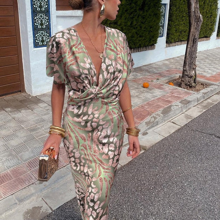Women's elegant maxi wedding guest dress with a stylish print, draped sleeves, and a flattering twist-front design.