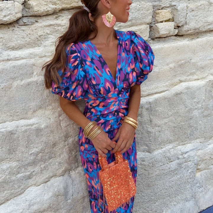 Chic women's formal printed midi dress with V-neck, puff sleeves, and feather trim detail, ideal for evening events.