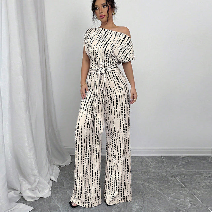 Elegant women's printed wide leg jumpsuit with a chic one-shoulder design and stylish belt, perfect for parties.