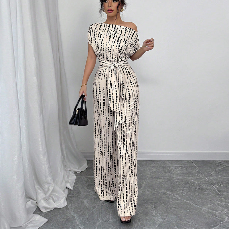 Stylish women's printed wide leg jumpsuit with a one-shoulder design and belt, ideal for summer parties & elegant occasions.